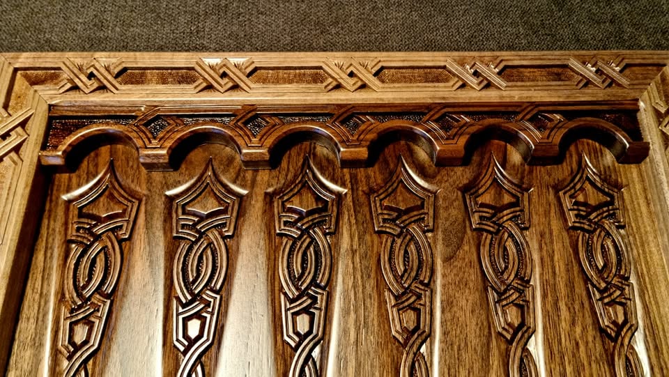 Carved arcade detail along the board side
