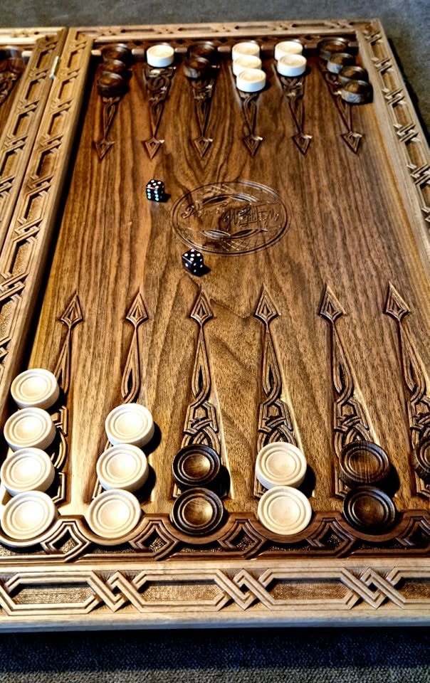 Hand-turned checkers and dice on the board