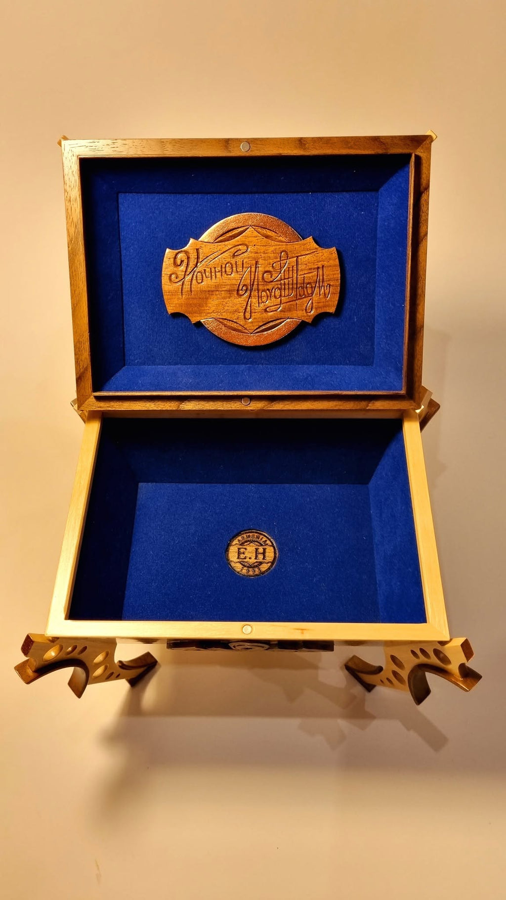Open vessel — royal blue velvet interior with maker's medallion
