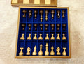 Chess Set by Edgar Hovhannisyan — gilded pieces in the blue velvet tray